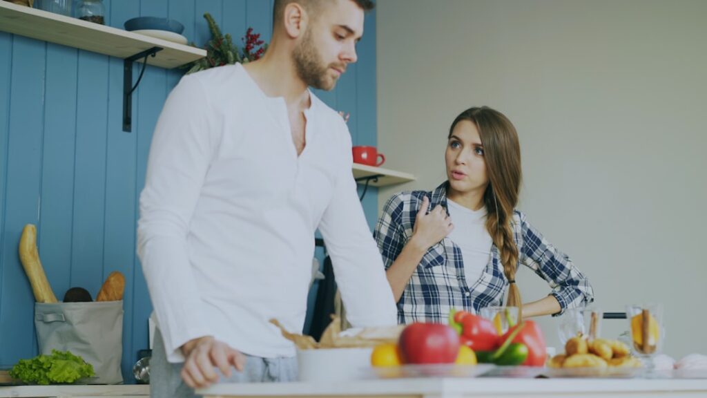 Young couple quarrels in the kitchen during breakfast time in the morning at home