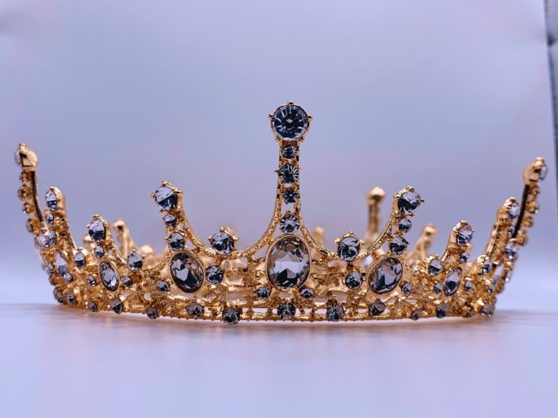A gold crown on a white background.