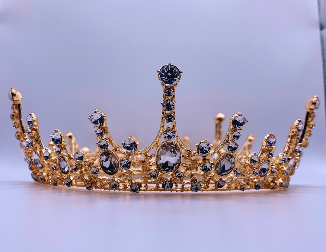 A gold crown on a white background.