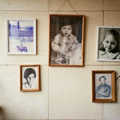 Volwassen vrouw kijkt peinzend naar oude familiefoto's