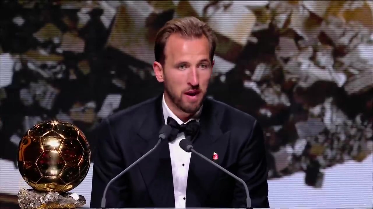 Harry Kane houdt zijn speech bij de uitreiking van de Ballon d'Or, met de gouden bal naast hem